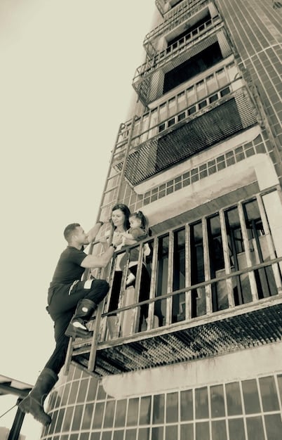 A construction site with workers building a modern, energy-efficient building. The image highlights various tradespeople, such as carpenters, electricians, and plumbers, working collaboratively on the project.