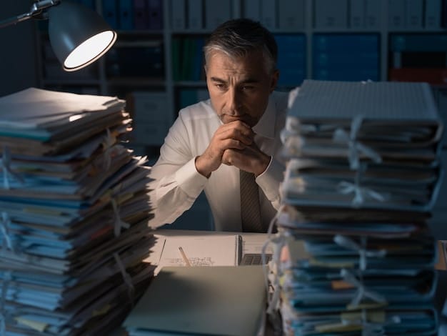 A close-up of a stressed-looking worker surrounded by stacks of paper documents, highlighting the pressure and potential for errors in manual data entry processes. The worker is frowning slightly.